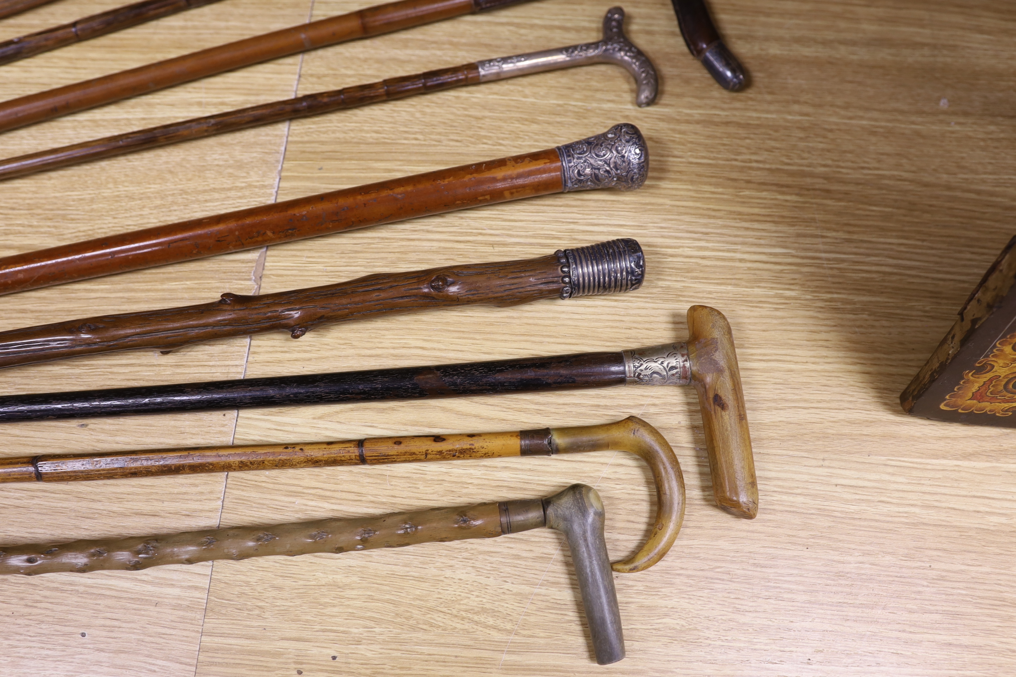 Four various decorative Victorian silver mounted walking sticks/canes, three horn handled canes and four others